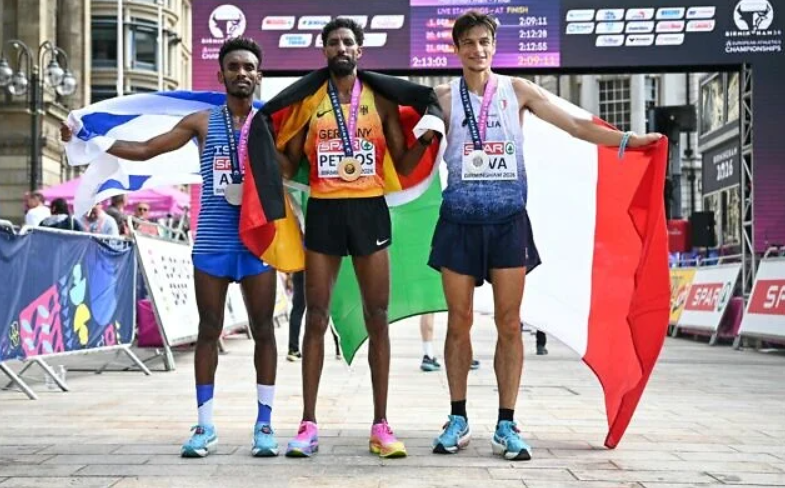 Bronzevinderen Gashau Ayale fra Israel, Tysklands Amanal Petros og Italiens sølvvinder Pietro Riva fejrer efter at have deltaget i herrernes maraton under EM i atletik i Birmingham den 16. august 2026.